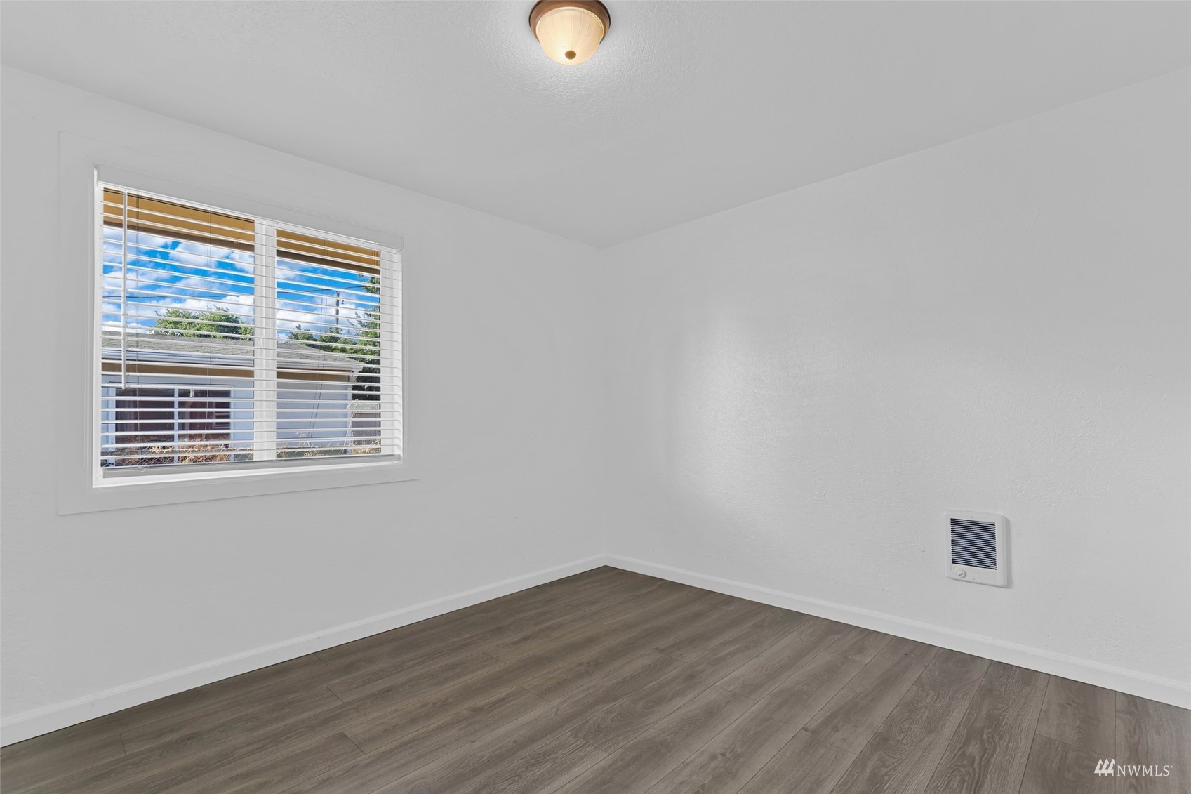 25 Rips Lane Southwest Lakewood, WA 98499 - Photo 24 of 33 a view of an empty room with wooden floor and a window