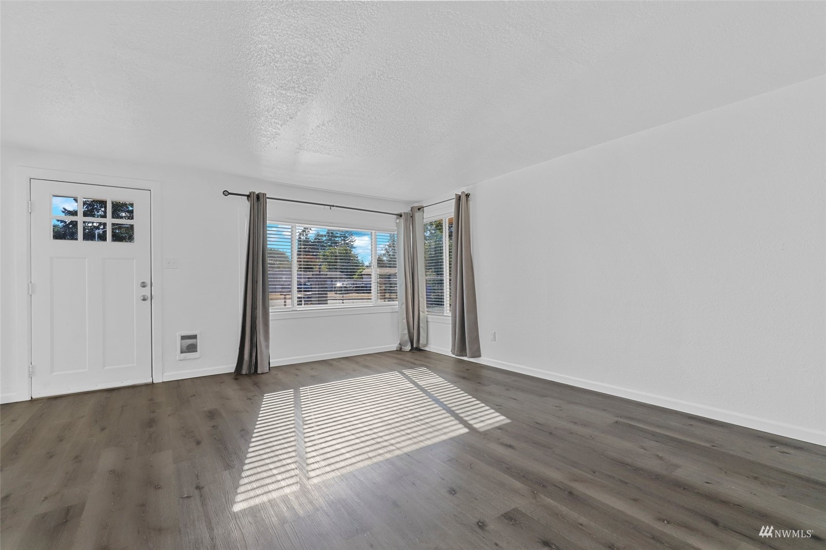 25 Rips Lane Southwest Lakewood, WA 98499 - Photo 6 of 33 an empty room with wooden floor and windows