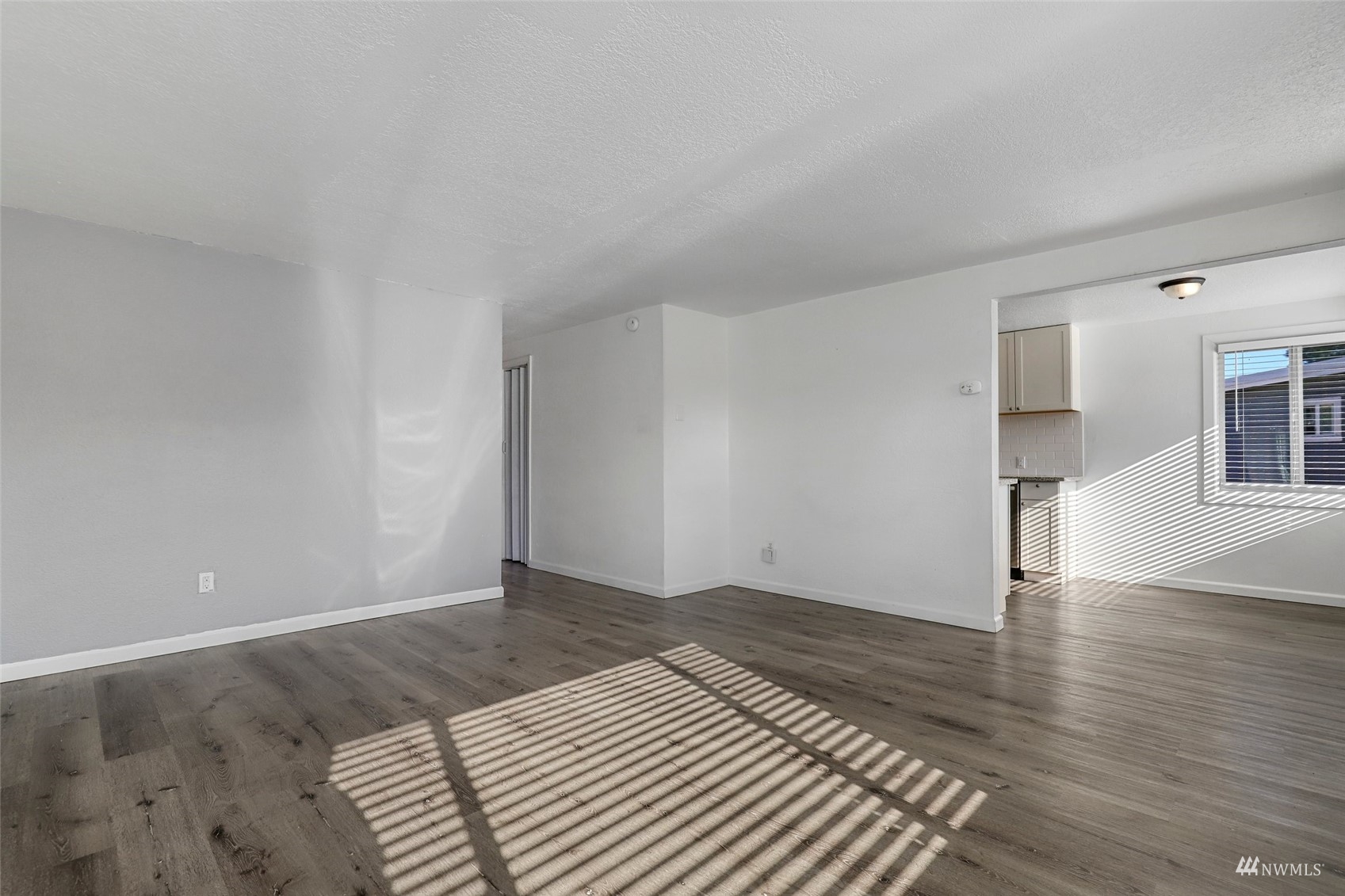 25 Rips Lane Southwest Lakewood, WA 98499 - Photo 9 of 33 a view of an empty room with wooden floor and a window