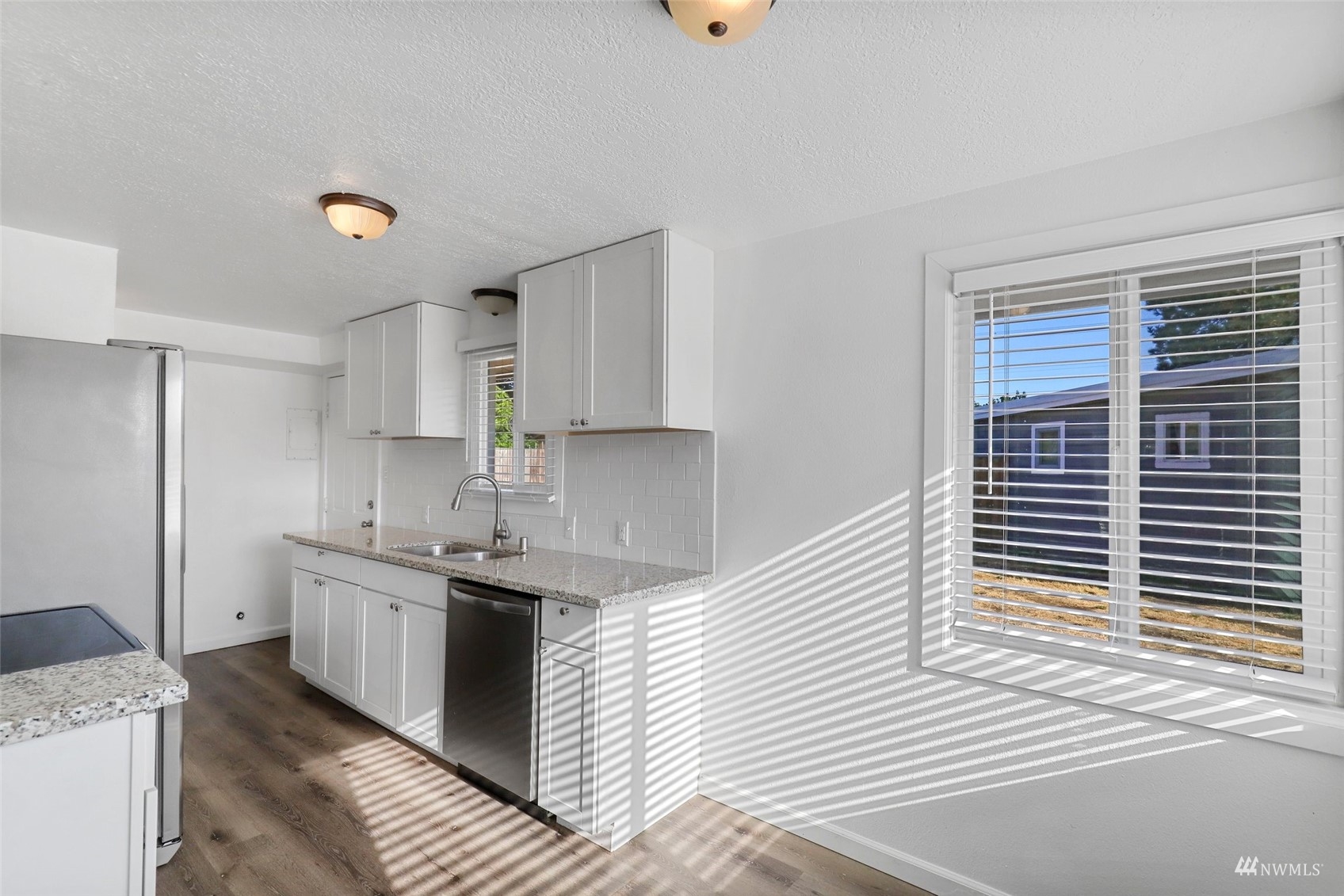 25 Rips Lane Southwest Lakewood, WA 98499 - Photo 10 of 33 a kitchen with stainless steel appliances granite countertop a sink and cabinets