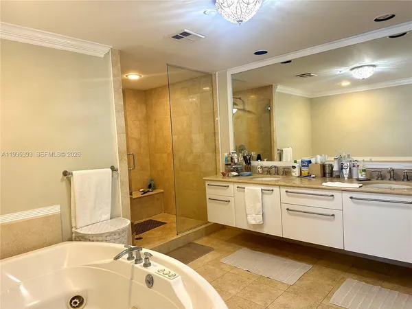 a bathroom with a tub sink and mirror