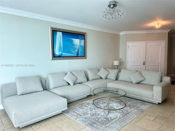 a living room with furniture a couch and painting on the wall