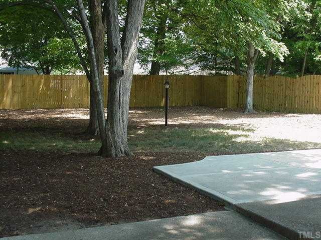 512 Chamberlain Street Raleigh, NC 27607 - Photo 10 of 11 a view of a yard with plants and a large tree