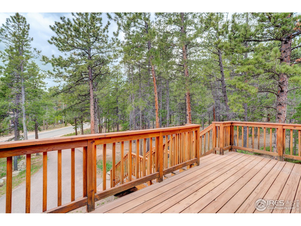 1927 Ridge Road Nederland, CO 80466 - Photo 2 of 38 a balcony with wooden floor and fence