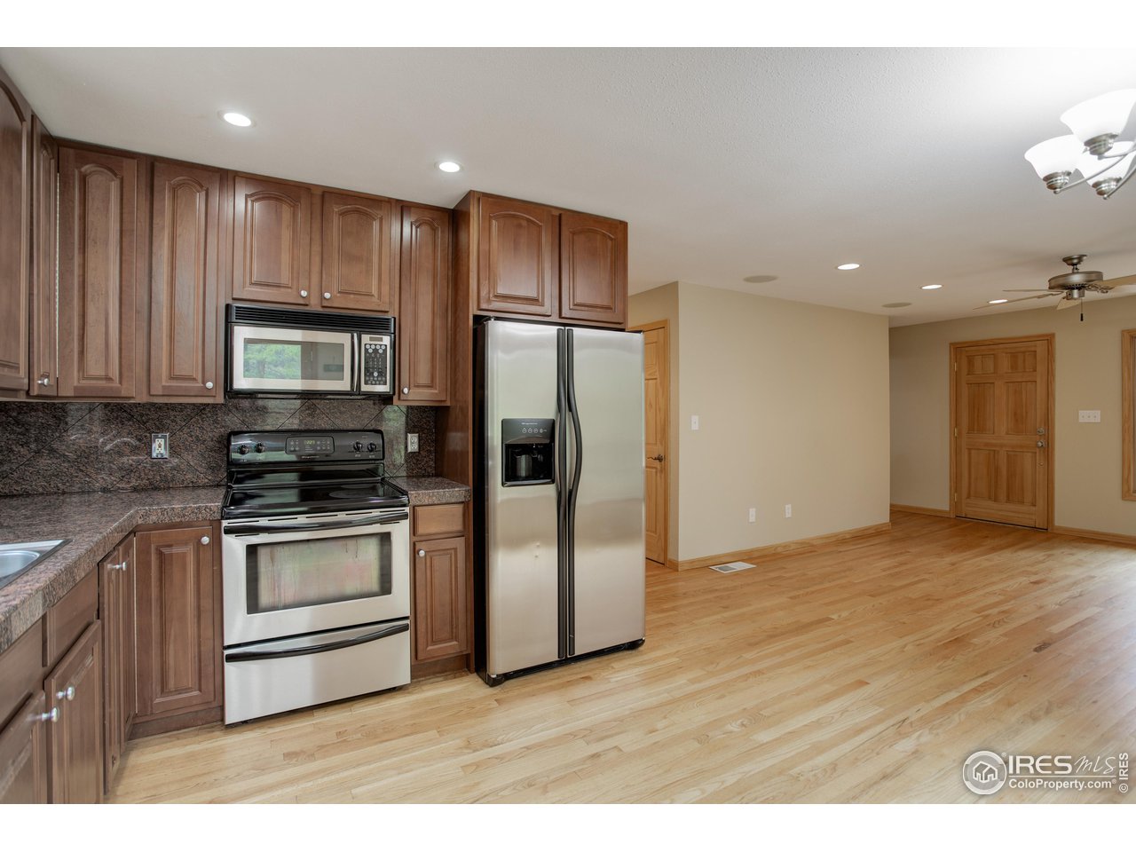 1927 Ridge Road Nederland, CO 80466 - Photo 24 of 38 a kitchen with stainless steel appliances granite countertop a refrigerator microwave and stove