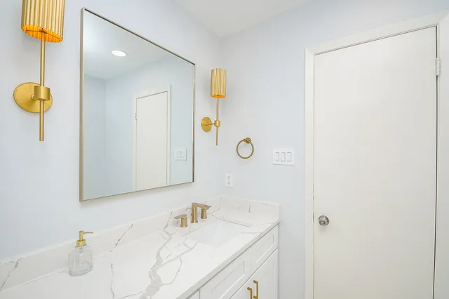 a bathroom with double sink and a mirror