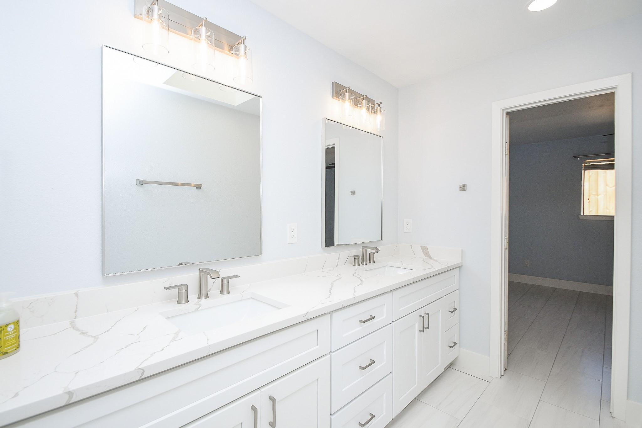 7902 Duffield Lane Houston, TX 77071 - Photo 22 of 31 a bathroom with double sink and a mirror