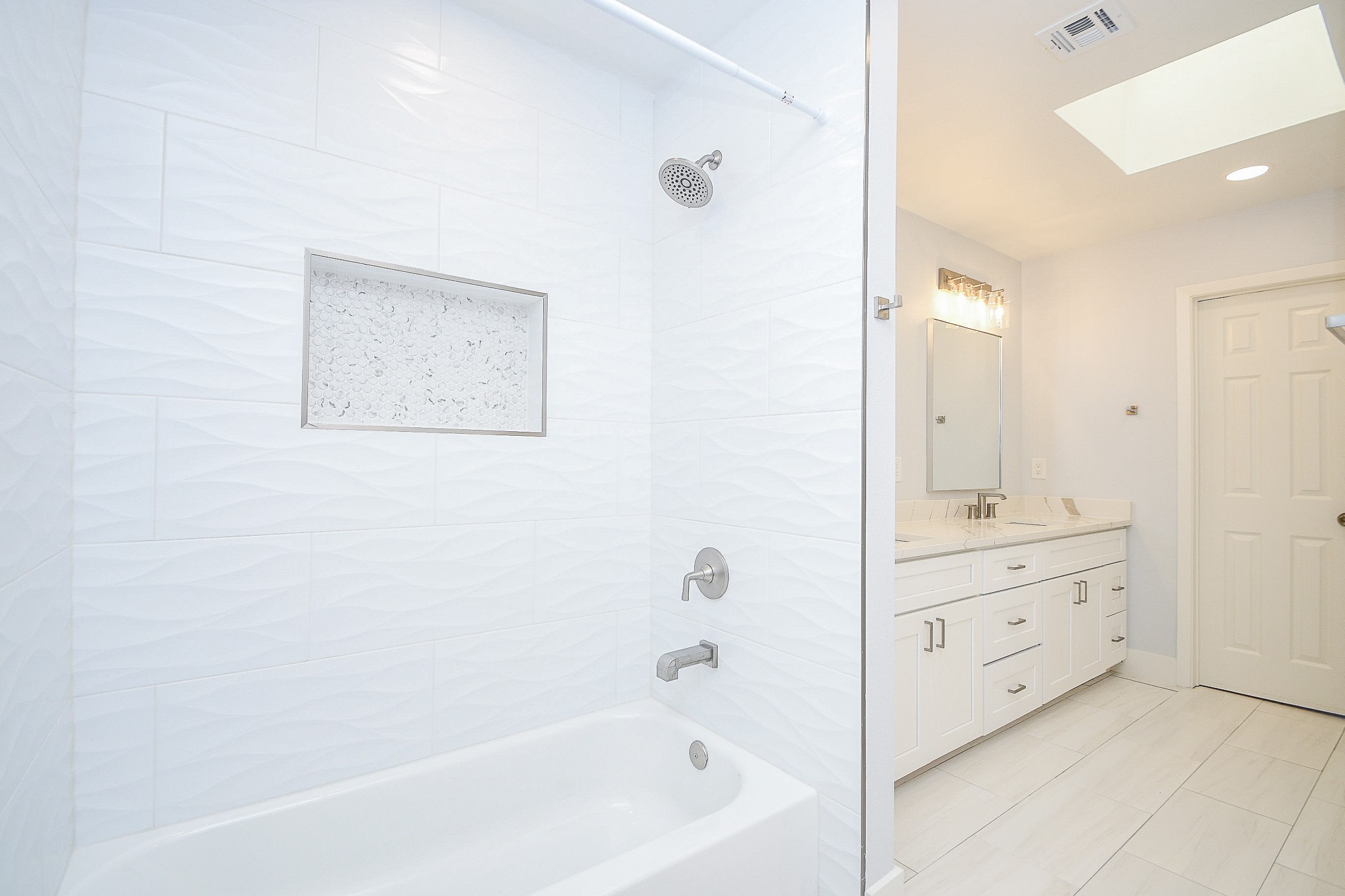 7902 Duffield Lane Houston, TX 77071 - Photo 23 of 31 a bathroom with a bathtub and a double vanity sink