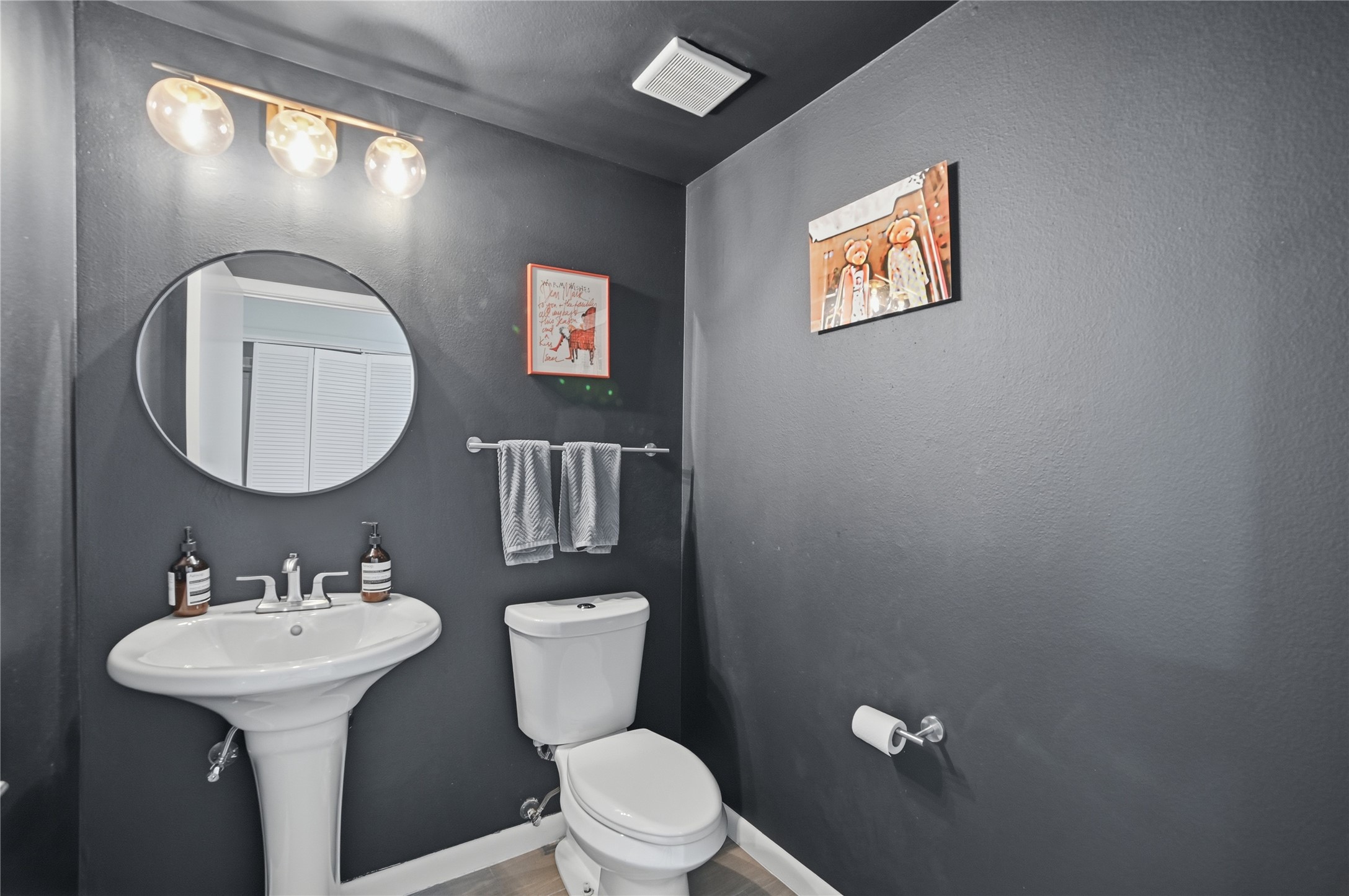 54 Rainey Street, Unit 1018 Austin, TX 78701 - Photo 24 of 32 a bathroom with a toilet sink and mirror