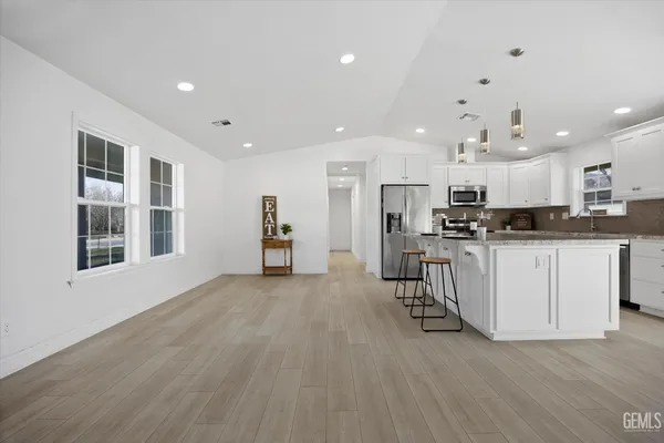 a view of kitchen with cabinets and wooden floor