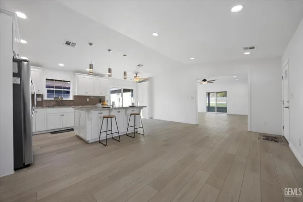 a kitchen with stainless steel appliances granite countertop a sink a stove and cabinets