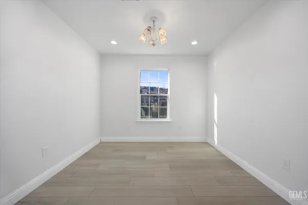 a view of an empty room with a ceiling fan