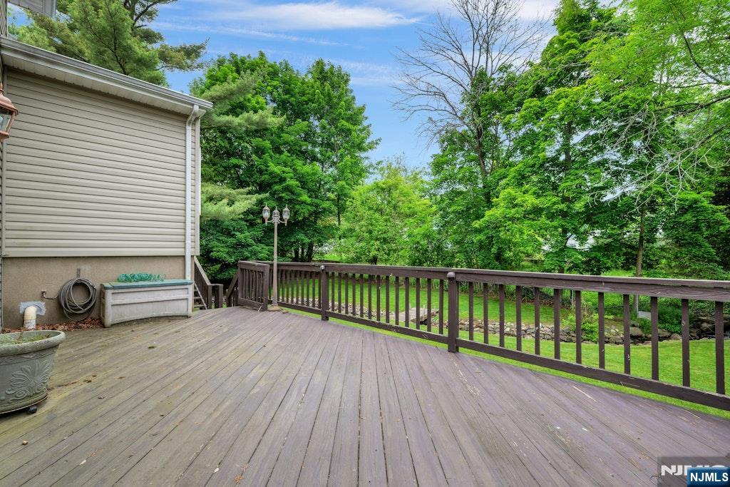 185 Ratzer Road Wayne, NJ 07470 - Photo 6 of 36 a view of a deck with wooden floor and fence