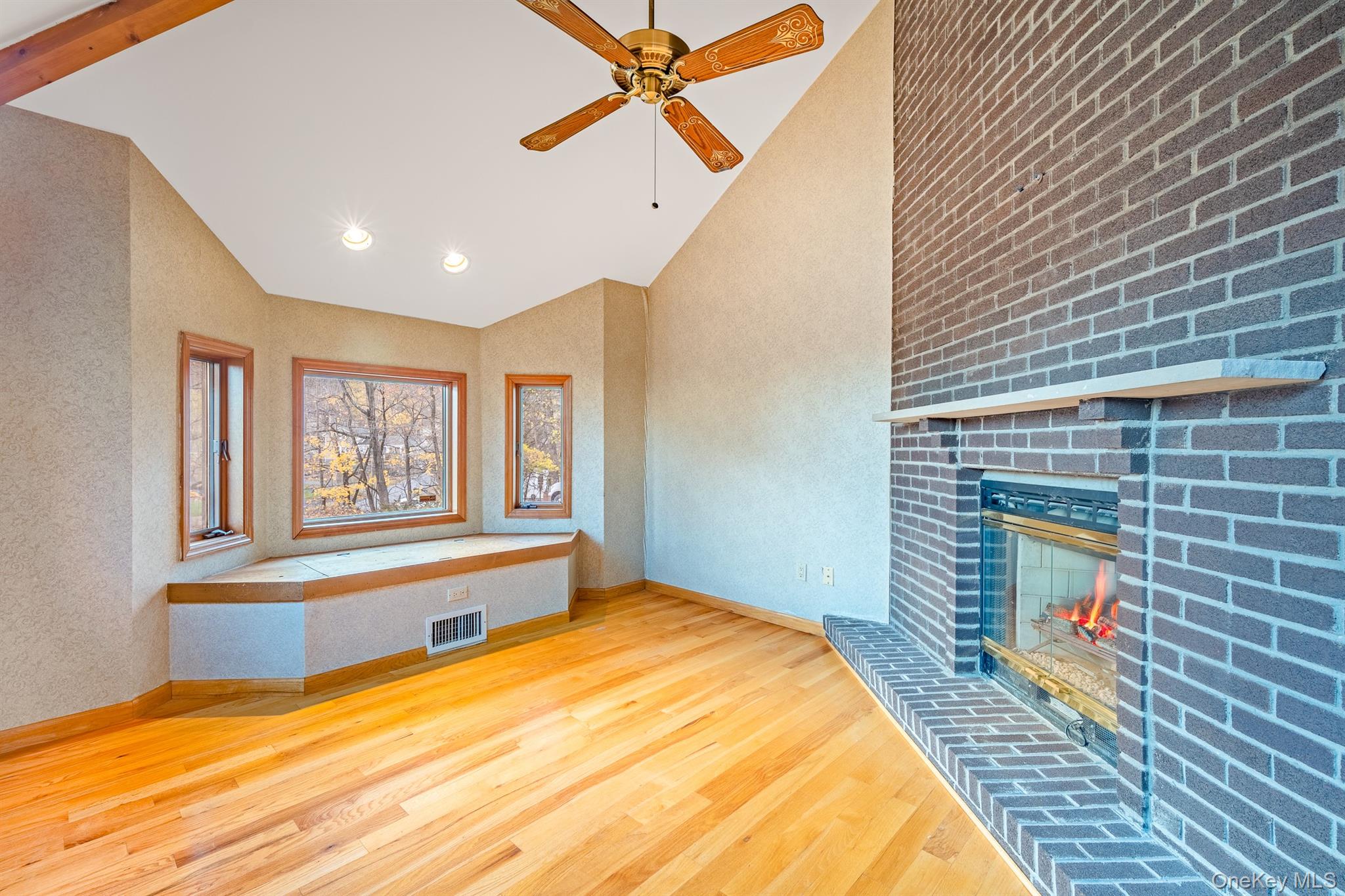 22 Weyant Road Fort Montgomery, NY 10922 - Photo 11 of 26 Unfurnished living room featuring light wood-style floors, a brick fireplace, high vaulted ceiling, a ceiling fan, and recessed lighting