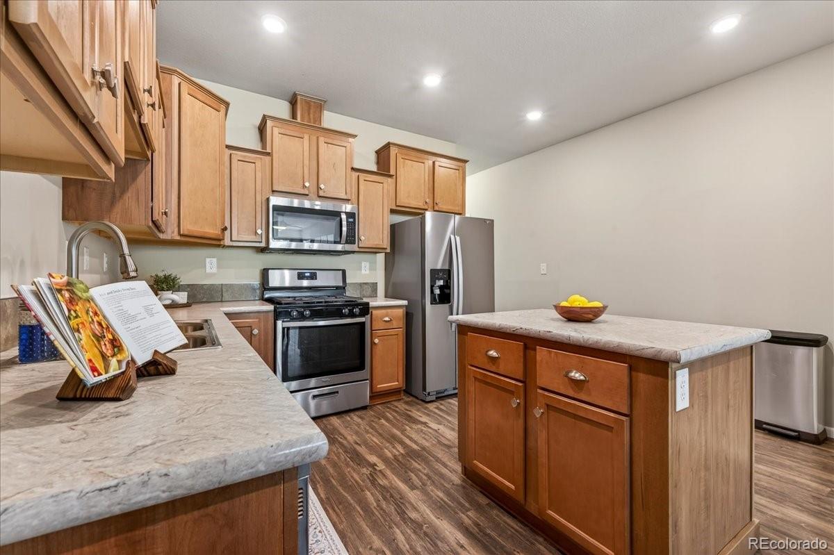 53 Brook Trout Loop Gypsum, CO 81637 - Photo 10 of 38 a kitchen with stainless steel appliances granite countertop a refrigerator a stove and a sink