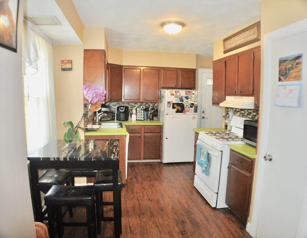 8 Rochambeau Street Fairhaven, MA 02719 - Photo 5 of 10 a kitchen with a table chairs refrigerator and cabinets