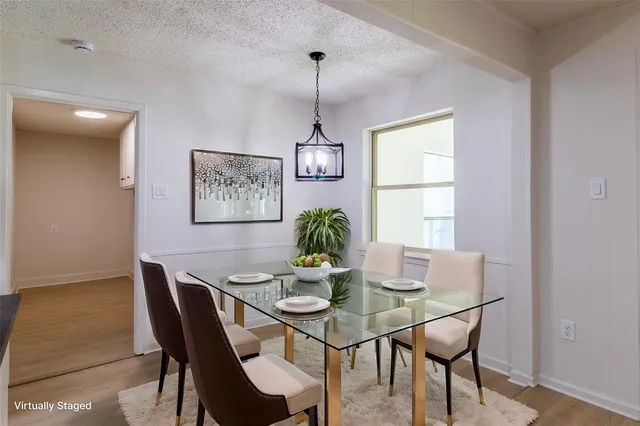 a dining room with furniture a window and a chandelier