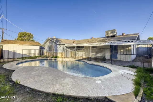 a view of a house with swimming pool and sitting area