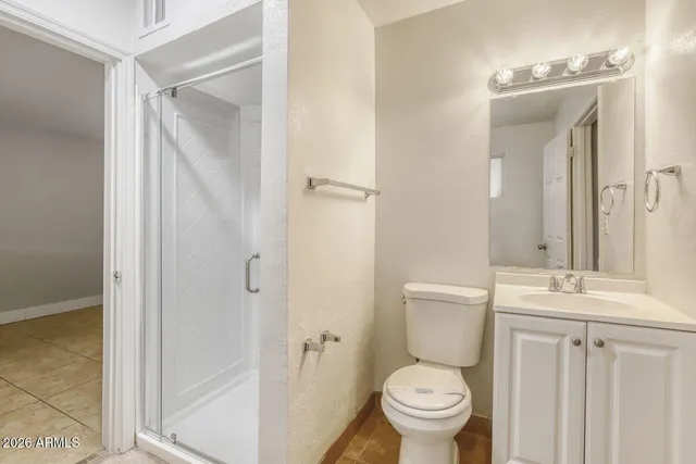 a white toilet sitting next to a bathroom sink