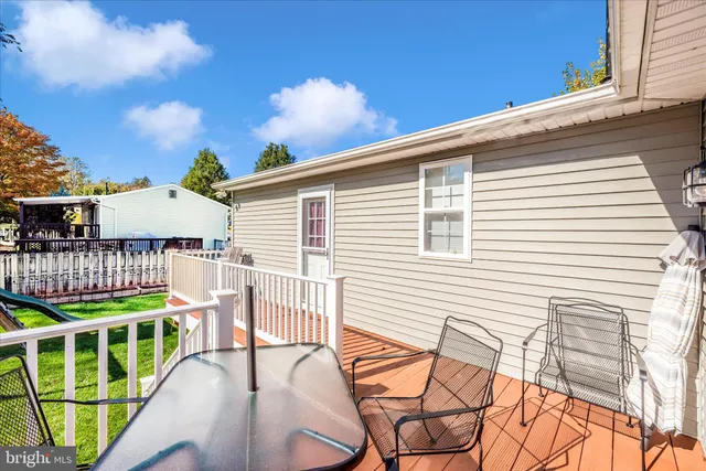 a balcony with table and chairs