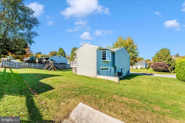 a yellow house with swimming pool in front of it