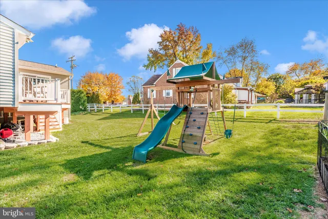a view of a house with a yard and swimming pool