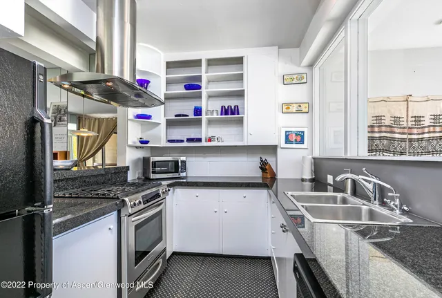 a kitchen that has a sink and a stove