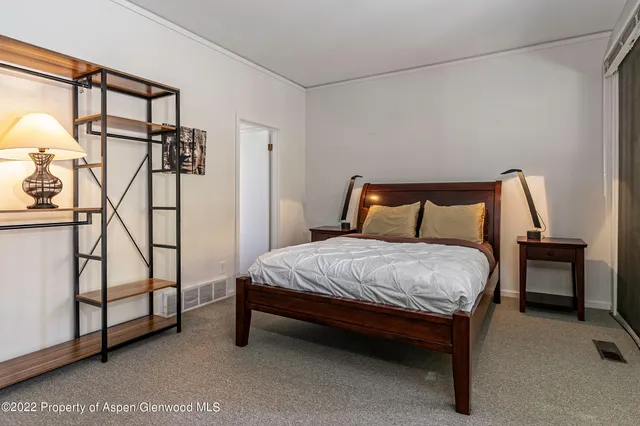 a bedroom with a bed and a dresser