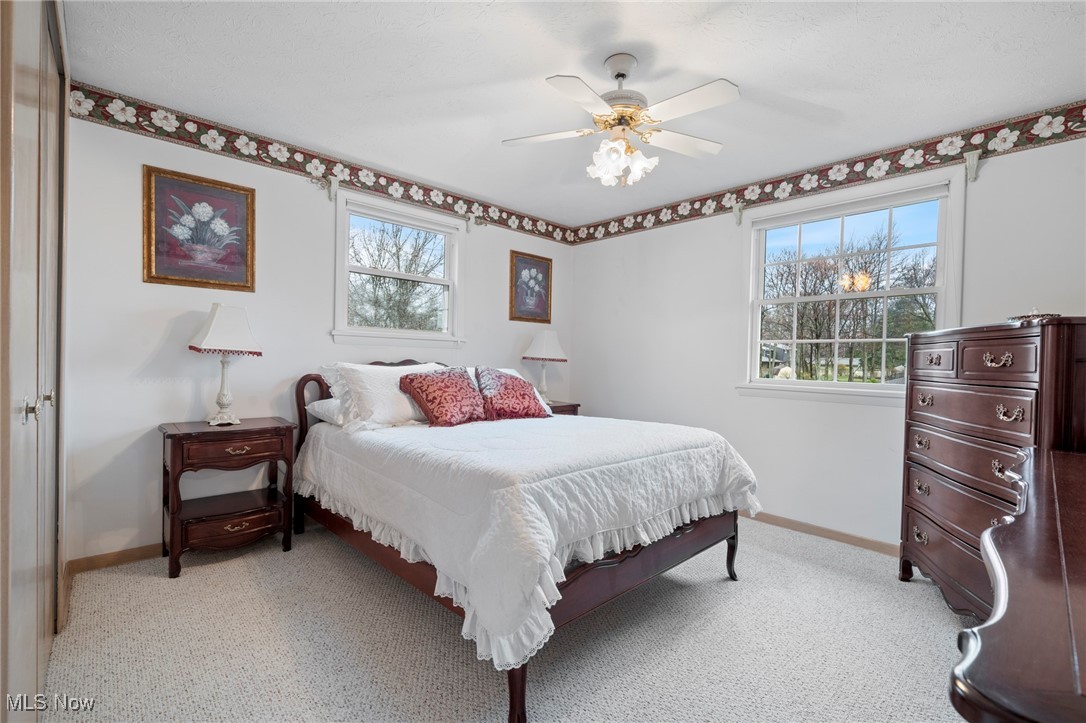 7353 Ames Road Cleveland, OH 44129 - Photo 25 of 45 Bedroom with baseboards, a ceiling fan, and light carpet