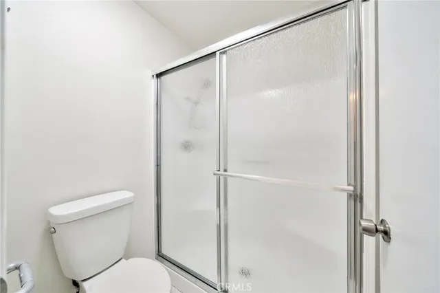 a bathroom with a shower and a toilet