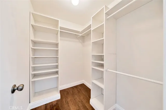 a view of walk in closet with empty racks