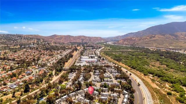 an aerial view of residential building with green space