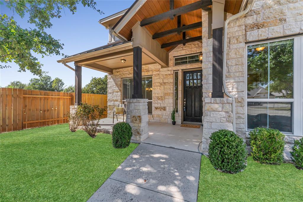 110 Magona Trail Georgetown, TX 78628 - Photo 4 of 38 A welcoming front porch with stone and wood accents enhances this home's inviting curb appeal.