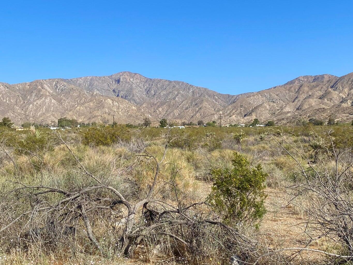 135 Bardell Road Morongo Valley, CA 92256 - Photo 26 of 29 a view of a mountain range in a cloudy sky