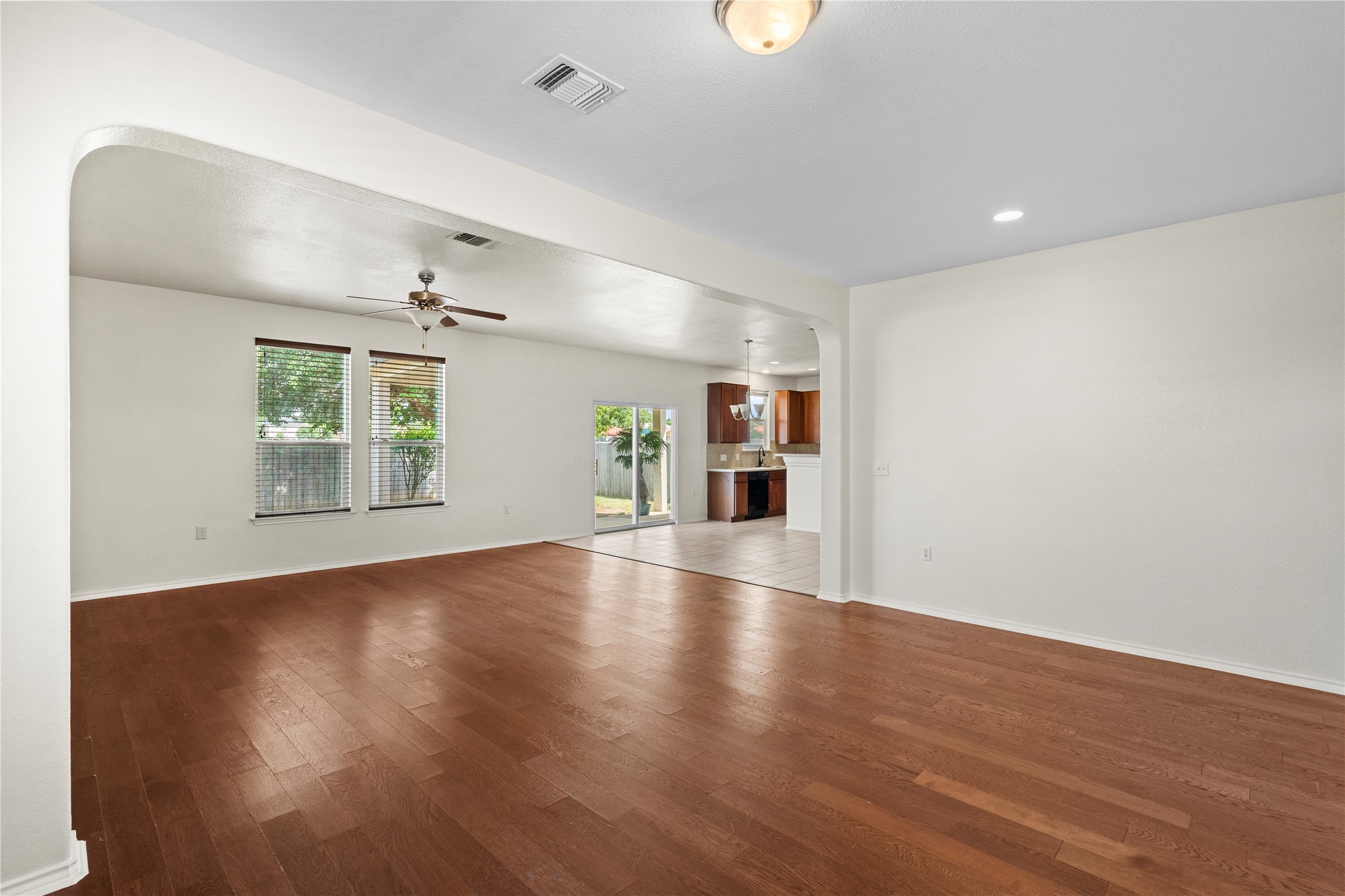 8613 Capitol View Drive Austin, TX 78747 - Photo 16 of 33 Natural light bathes this spacious living area, boasting gleaming hardwood floors and an open-concept flow into the kitchen.