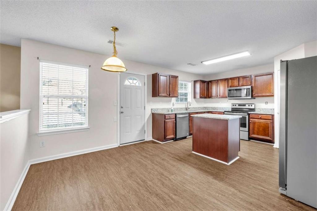 6724 Overlook Ridge College Park, GA 30349 - Photo 12 of 34 a kitchen with kitchen island granite countertop stainless steel appliances cabinets a sink and a window