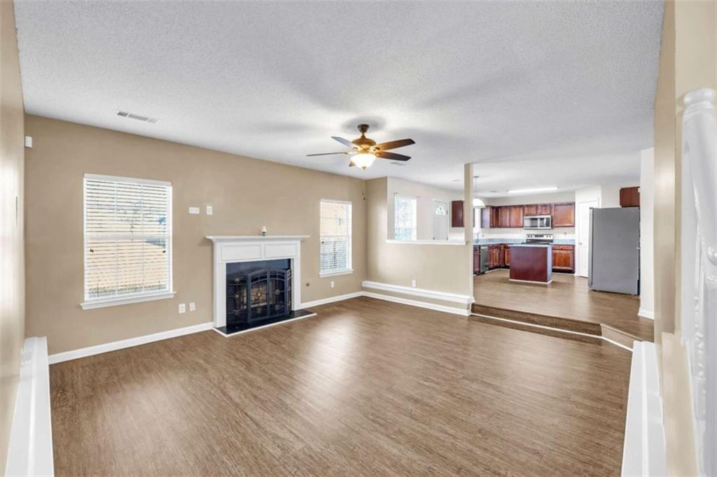 6724 Overlook Ridge College Park, GA 30349 - Photo 8 of 34 a view of a livingroom with a fireplace a ceiling fan and windows