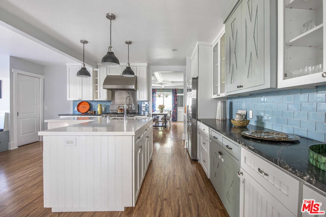 55 West Altadena Drive Altadena, CA 91001 - Photo 15 of 42 a kitchen with stainless steel appliances granite countertop a sink a stove and a wooden floors