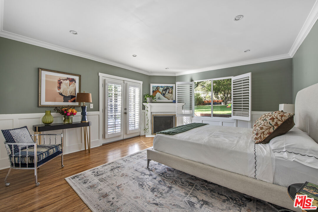 55 West Altadena Drive Altadena, CA 91001 - Photo 21 of 42 a spacious bedroom with a bed a table and wooden floor