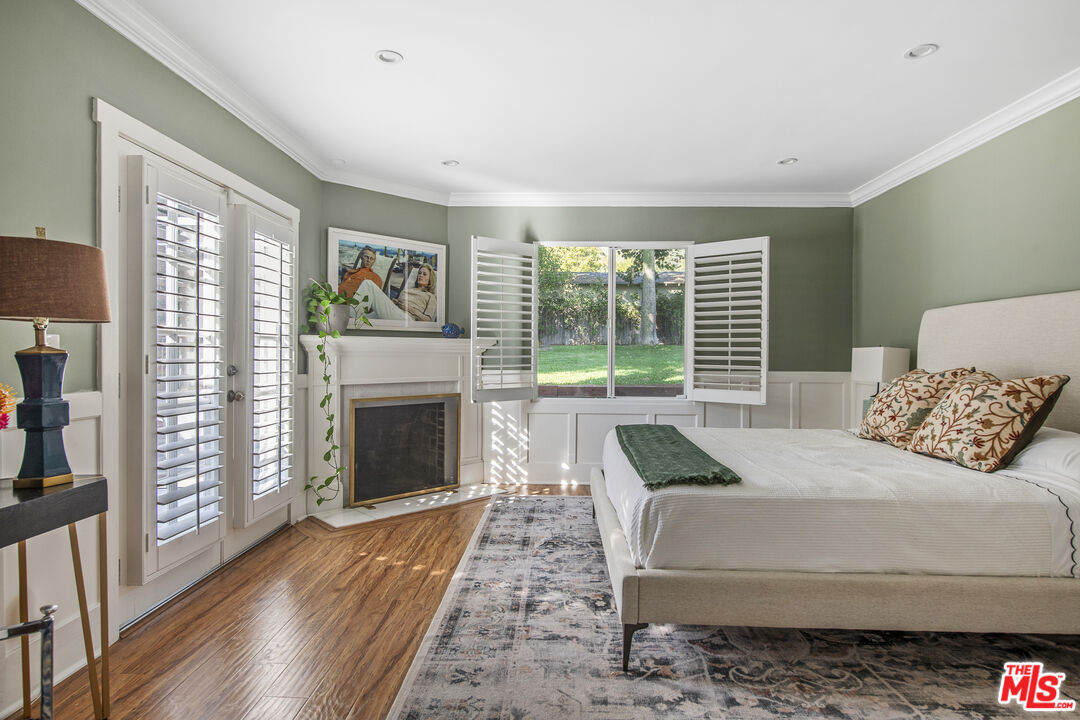 55 West Altadena Drive Altadena, CA 91001 - Photo 22 of 42 a bedroom with a large bed and a fireplace
