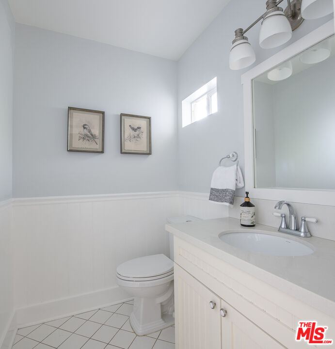 55 West Altadena Drive Altadena, CA 91001 - Photo 28 of 42 a bathroom with a toilet sink and mirror