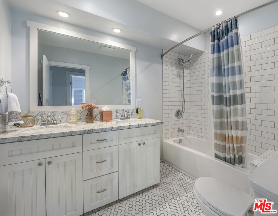 55 West Altadena Drive Altadena, CA 91001 - Photo 31 of 42 a bathroom with a granite countertop sink mirror and bathtub