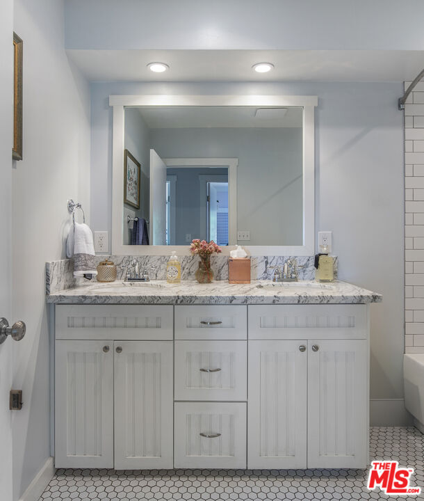 55 West Altadena Drive Altadena, CA 91001 - Photo 32 of 42 a bathroom with a granite countertop sink and a mirror
