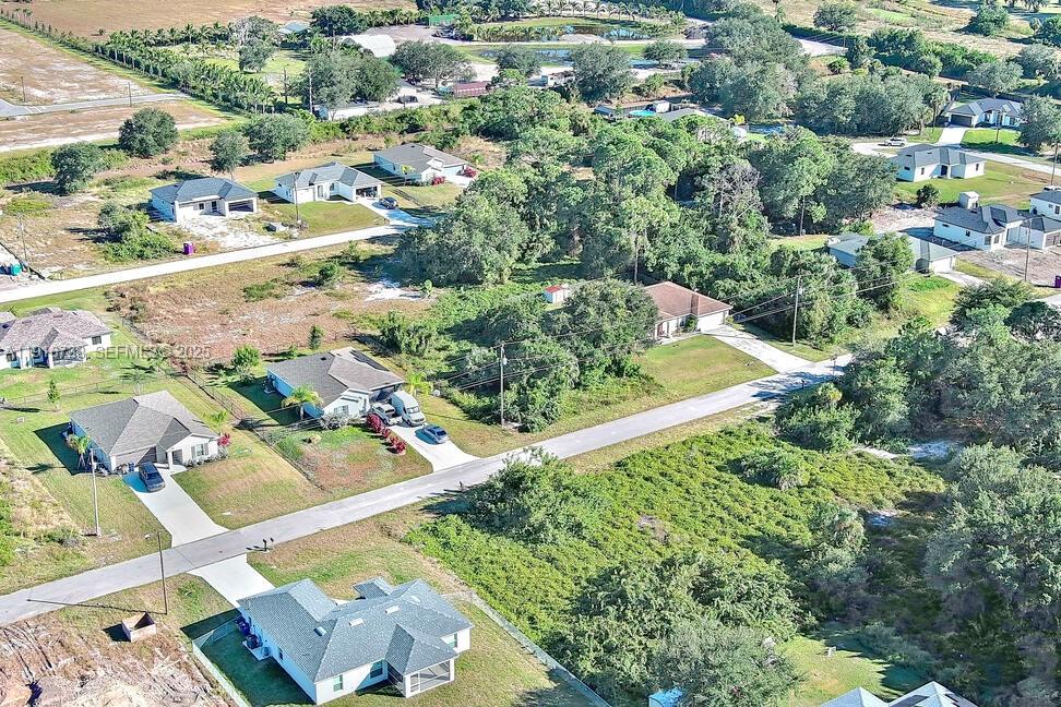 341 Ranchito Avenue Lehigh Acres, FL 33974 - Photo 13 of 22 an aerial view of residential houses with outdoor space