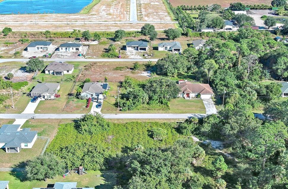 341 Ranchito Avenue Lehigh Acres, FL 33974 - Photo 14 of 22 a view of a lake with a building in the back
