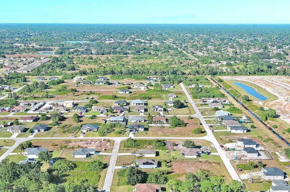 341 Ranchito Avenue Lehigh Acres, FL 33974 - Photo 20 of 22 an aerial view of residential houses with outdoor space