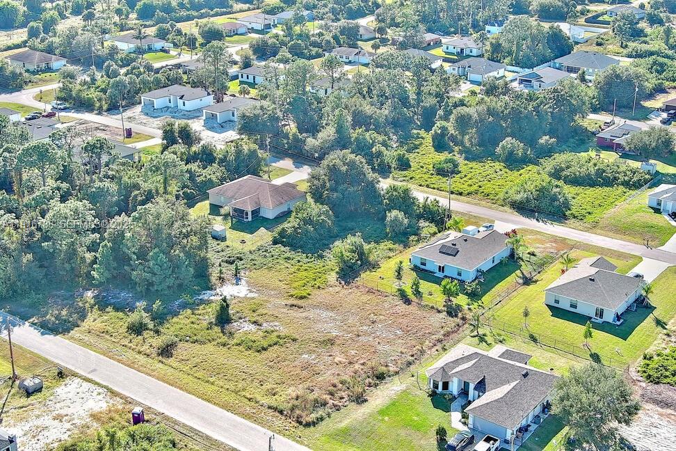 341 Ranchito Avenue Lehigh Acres, FL 33974 - Photo 22 of 22 an aerial view of residential houses with outdoor space
