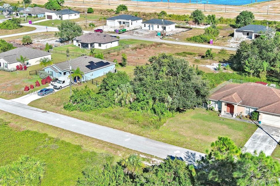 341 Ranchito Avenue Lehigh Acres, FL 33974 - Photo 7 of 22 an aerial view of residential houses with outdoor space and street view