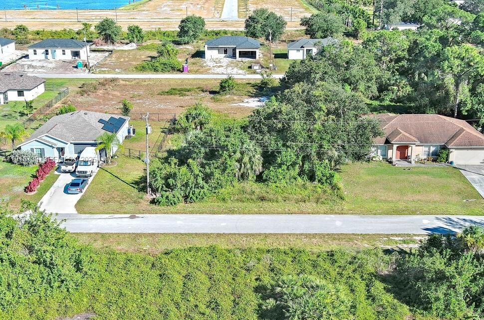 341 Ranchito Avenue Lehigh Acres, FL 33974 - Photo 8 of 22 an aerial view of a house with a yard