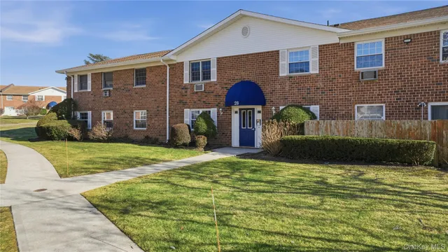 a view of house with yard and outdoor seating